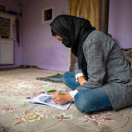 On February 10 2025, Ramzia*, 15, is drawing at home. She has been out of school for the past three and a half years. She was in eighth grade when girls were banned from school.