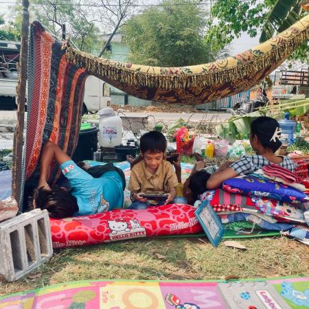 Children and families take shelter in makeshift outdoor spaces in Mandalay, Myanmar, following the devastating 7.7 magnitude earthquake that struck on 28 March 2025.