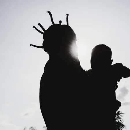 A girl holding a baby