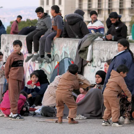 Displaced families gather in the streets to reach safety