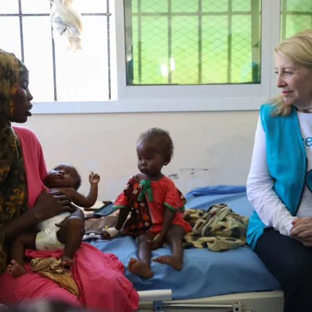 UNICEF Executive Director Catherine Russell speaks with a mother whose children are receiving nutrition support in Somalia.