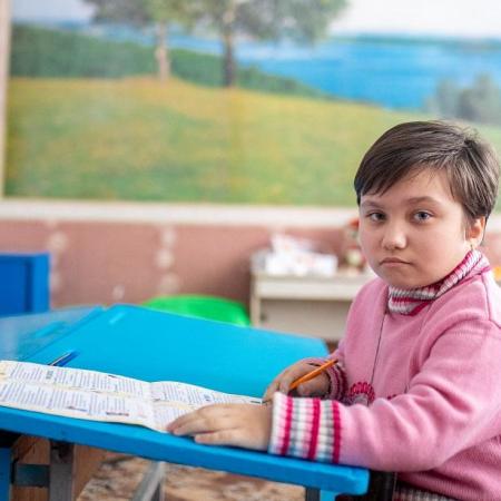 A girl sits in a classroom in Eastern Ukraine.