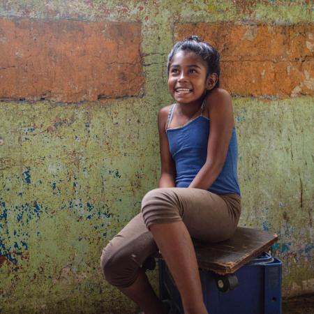 Duglianis sits inside her home in Petare, Venezuela.