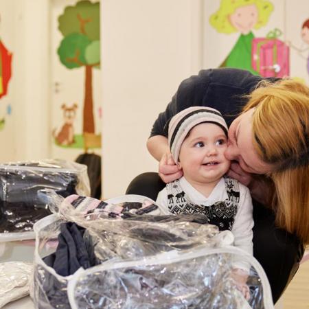 Mother putting on a warm cap on child's head