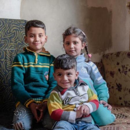Haifa's children pose inside their temporary home