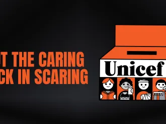 The image depicts UNICEF Canada's iconic Halloween box with the tagline " Put the caring back in scaring"