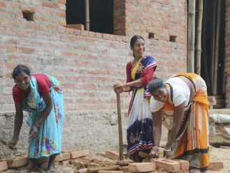 Three rani mistris work at digging a new toilet.