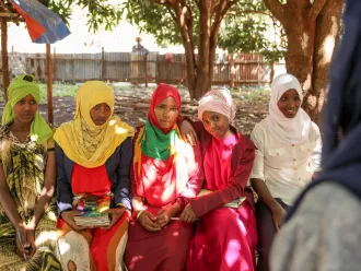 Girls pose together outside their school in Ethiopia.