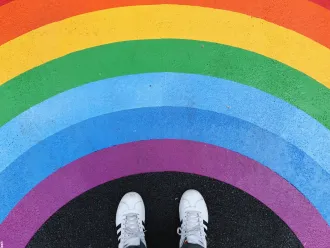 Feet standing in a rainbow