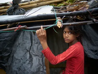 Young girl under shelter bracing for Cyclone Amphan