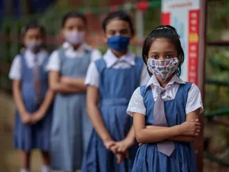 A group portrait of students wearing masks inside the school premises at Gandaria Mohila Shomity Government Primary School, Dhaka, Bangladesh on 12 September 2021.