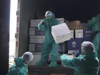 Workers unload medical supplies in Ecuador.
