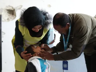 A child receives an oral vaccination.