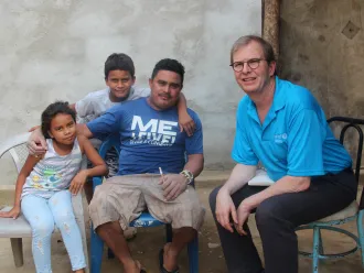 David with a migrant family in Honduras.