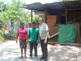 David poses with a migrant family in Honduras.