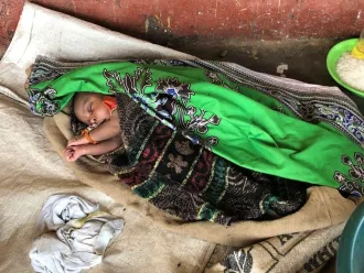 Baby Teresa sleeps on a makeshift mat.