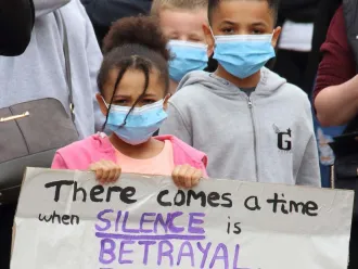 Two children hold a sign at a Black Lives Matter protest.