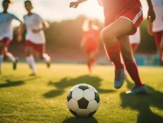 Kids playing football on a field. 