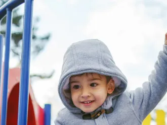 A boy playing at a playground.