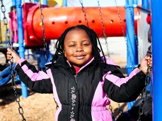  Happy child on playground swing set
