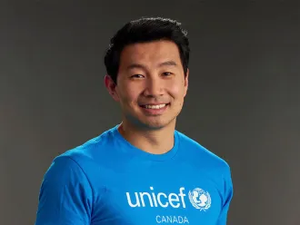 Simu Liu in a cyan UNICEF Canada T-Shirt
