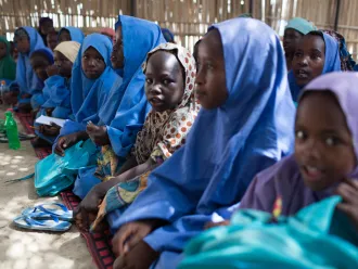 girl sitting in temporary school