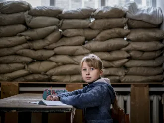 Lera Nagormay, 10, sits for a photograph in a classroom at school in Marinka, Donetsk Oblast, Ukraine.