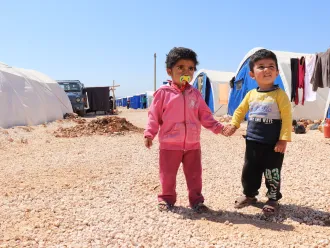 Children holding hands, Syria, 2018.