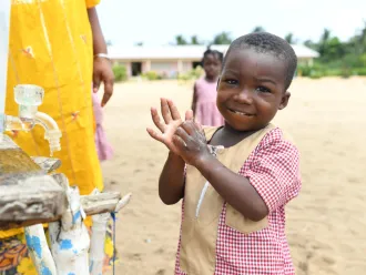 Children wash their hands at school.