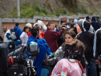 A migrant girl waits for processing