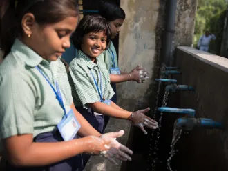 Student wash their hands in India. 