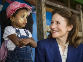 UNICEF Executive Director Henrietta Fore sits with a child during visit to Myanmar