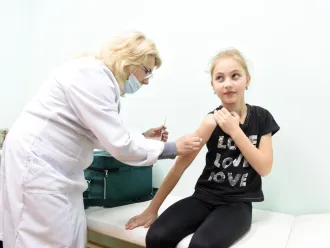 A young girl receives an MMR vaccine.