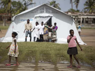Girls in front of a tent