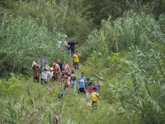 A group of migrants crosses an illegal path between Colombia and Venezuela.