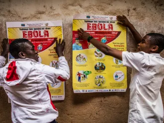 School children put up posters with ebola advisories.