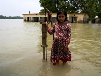 girl in front of her school in Bangladesh