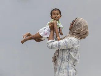 A mother holds her baby in India