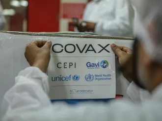 In India, on 23 February 2021, an employee packs and prepares for shipment a box containing COVID-19 vaccines for the COVAX facility at a manufacturer in Pune, a city located in the western Indian state of Maharashtra.