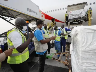 On 24 February 2021, staff unloads the first shipment of COVID-19 vaccines distributed by the COVAX Facility at the Kotoka International Airport in Accra, Ghana's capital.
