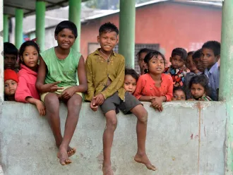 Children pose for a photograph at Mahabirbari Tea estate in Dibrughar district of Assam.
