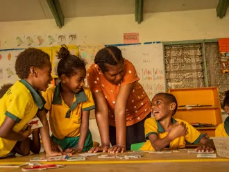 On 28th October, Janet, Special Needs Teacher, helps class 1 students in mainstream classroom during a group activity in Freswota, Port Vila, Vanuatu