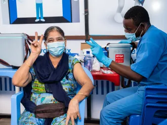 Shah SULTANA FARISHTA, 66,is being vaccinated against COVID-19 at the HJ Hospital.