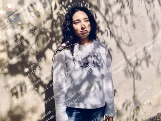 Houda, 19, poses for a portrait outside her family’s home near Grenoble, France.