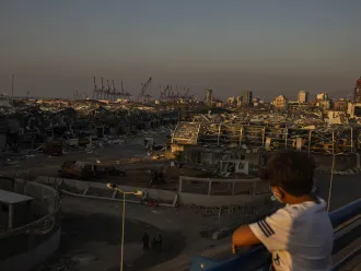 A young Lebanese looks over the area of the Beirut Port explosions on Thursday, August 6, 2020. The massive blast killed more than 20 people including six children; over 6,500 injured including an estimated 1,000 children.