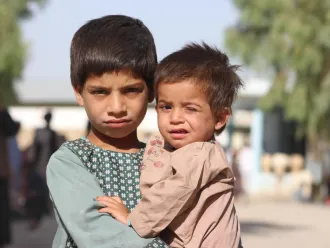 From left: Mohammad Dawood, 5 years old and his brother Sayed Ahmad, 2 years old, have been moved from Maiwand District to Haji IDP camp due to conflict and war. His father owns a shop, and he has five siblings in his family of seven. 