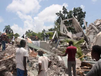 People search through the rubble of what used to be the Manguier Hotel after the earthquake hit in Haiti.