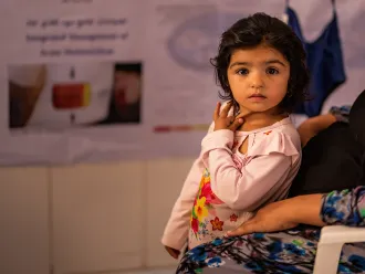 two-year-old Fatima, waits her turn for health and nutrition screening at Bab-e-Bargh health centre where UNICEF-supported immunization, health, nutrition and ante/post-natal care continue to be provided in Herat city’s largest health clinic.