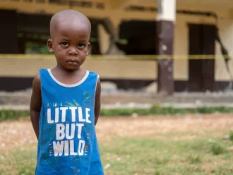 A young child stands in front of his school destroyed during the 2021 earthquake in Haiti.Notre Dame du Perpétuel Secours de Latibolière School destroyed following the earthquake that affected the South of Haiti on 14th August 2021.