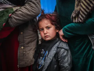 Children and families queue in front of a UNICEF mobile clinic in northeast Syria. 